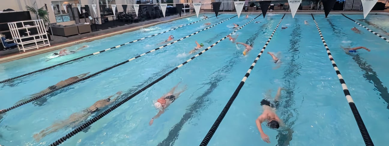 Swimmers pushing off the wall at The Plunge